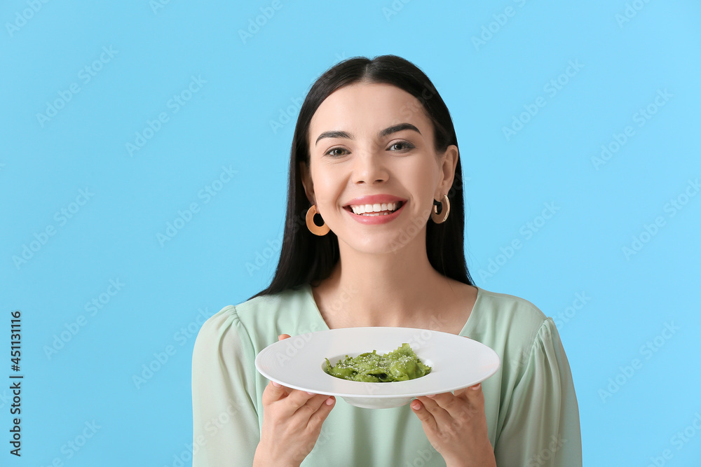 Beautiful young woman with tasty ravioli on color background Beautiful young woman with tasty ravioli on color background