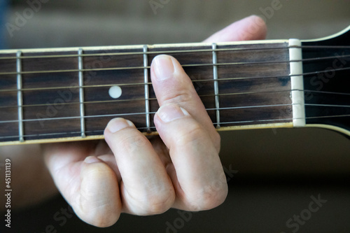 hand holding guitar chord for playing