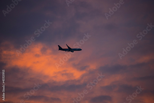 airplane flying in the evening sky