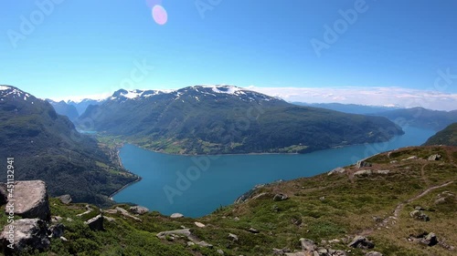 Panoramic timelapse showing Olden and Innvikfjord seen from mountain Hoven and Loen Skylift restaurant - Summer static timelapse with moving boats and clouds in background photo
