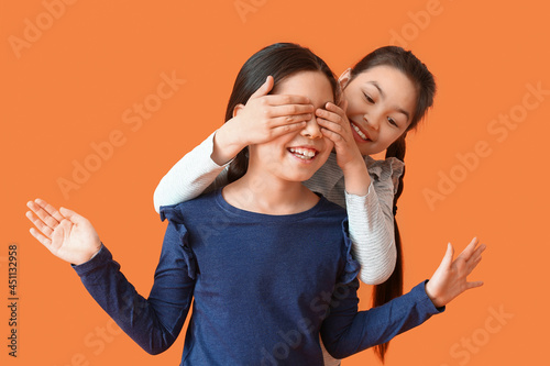 Happy girl covering eyes of...