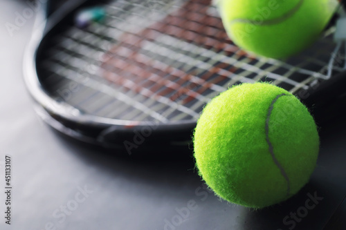 Sport and healthy lifestyle. Tennis. Yellow ball for tennis and a racket on the table. Sports background with tennis concept.