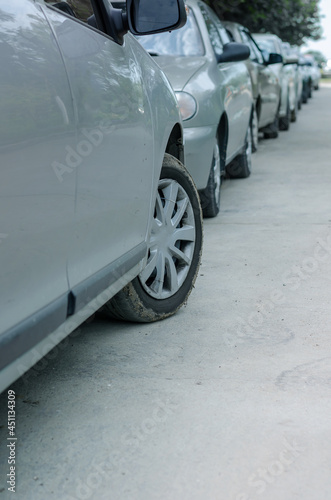 Rows of cars parked on the side of the road in a residential are