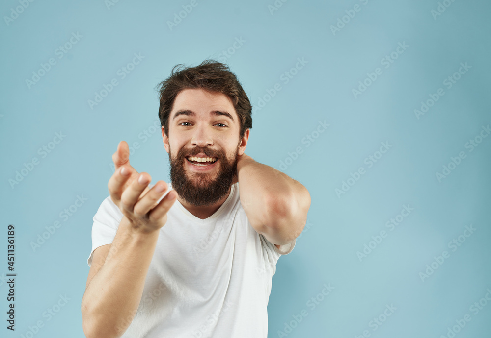Man in a white t-shirt happy facial expression blue background Man in a white t-shirt happy facial expression blue background