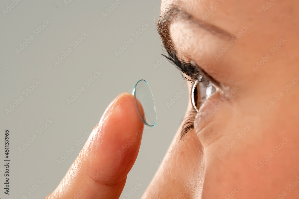 Fototapeta premium Close-up shot of young woman wearing contact lens