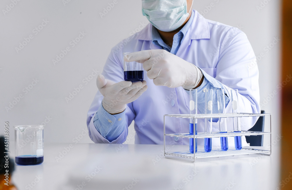 Science innovative Male medical or scientific laboratory researcher performs tests with blue liquid in laboratory. equipment science experiments technology Coronavirus Covid-19 vaccine research Science innovative Male medical or scientific laboratory researcher performs tests with blue liquid in laboratory. equipment science experiments technology Coronavirus Covid-19 vaccine research