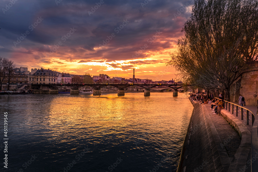 Paris, France - March 26, 2021: Beautiful sunset on the banks of the Seine in Paris