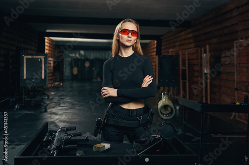 Woman with a leather gun holster on her hip looking ahead photo