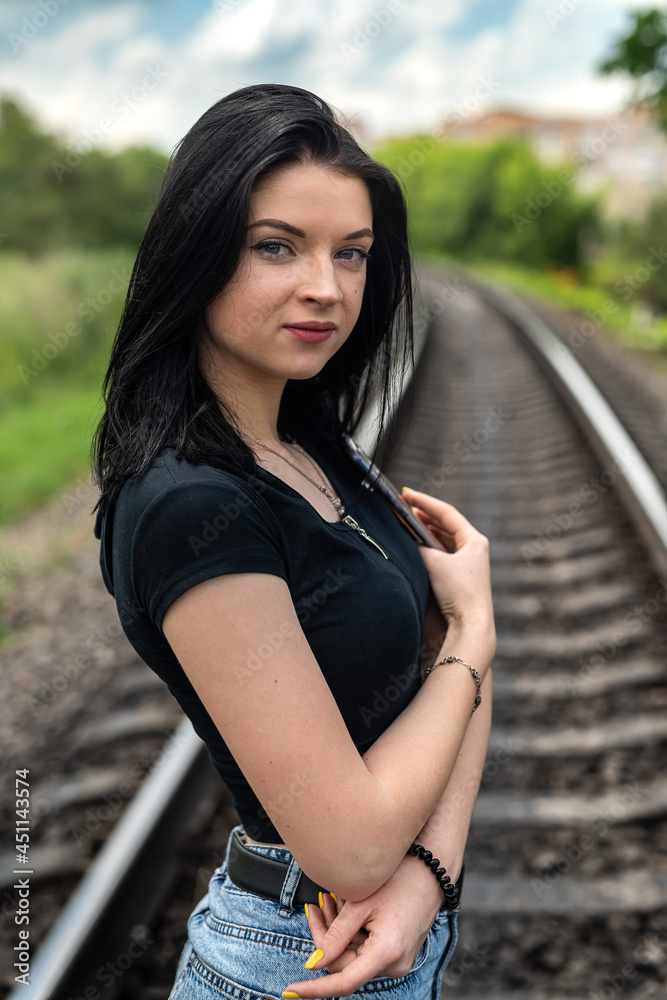  prety lady enjoy summer time on the train track in the nature