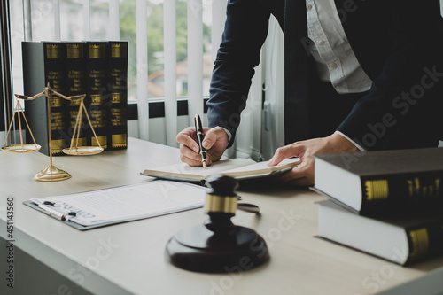 Professional man lawyers work at a law office There are scales, Scales of justice, judges gavel, and litigation documents. Concepts of law and justice