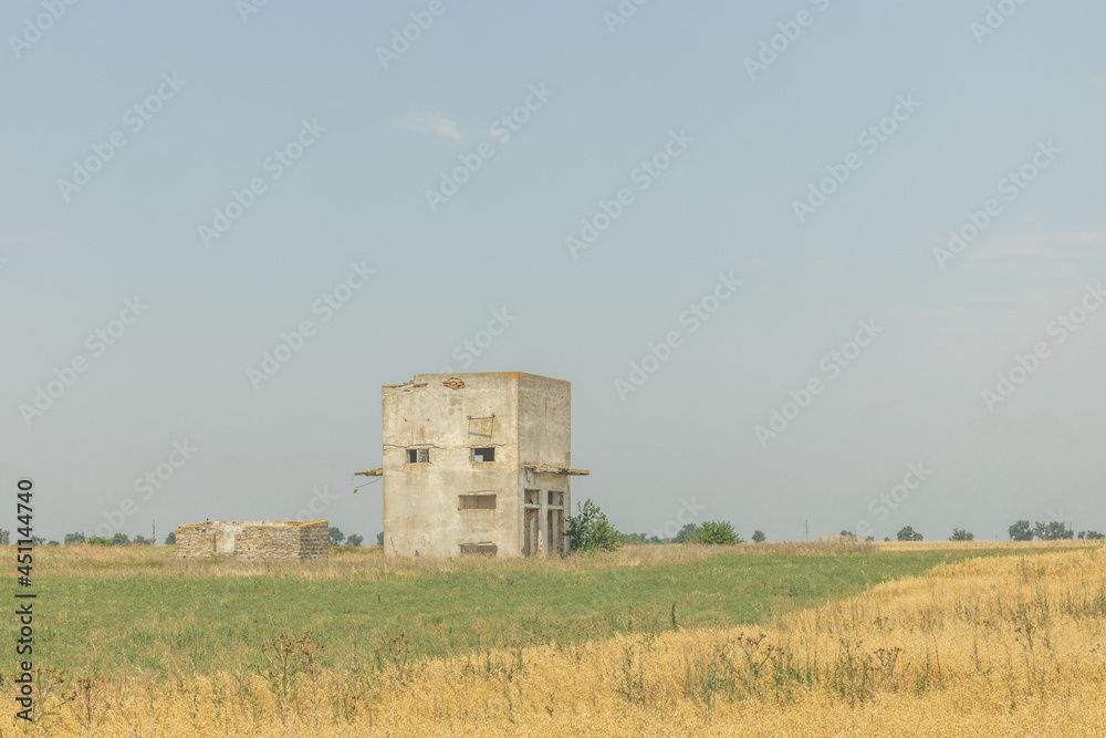 An unfinished abandoned house in a field