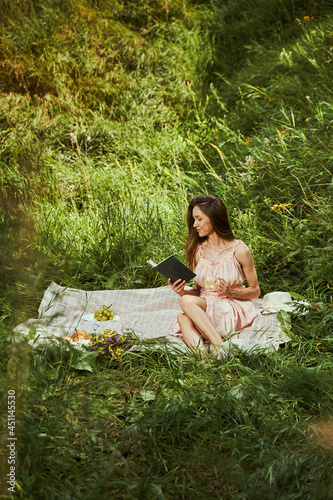Beautiful lady enjoying her favorite book outdoors © Viacheslav Yakobchuk