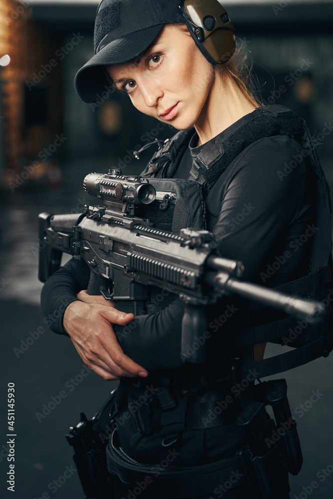 Female sniper preparing to shoot a gun