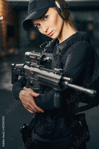 Female sniper preparing to shoot a gun