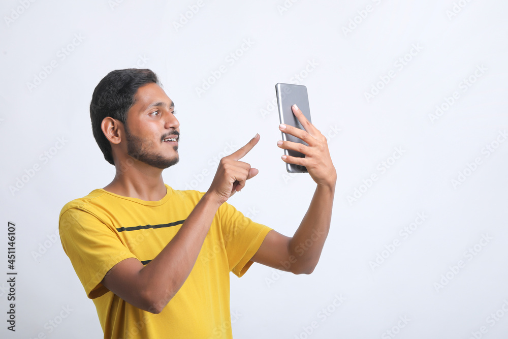 Young indian man using tablet over white background. Young indian man using tablet over white background.