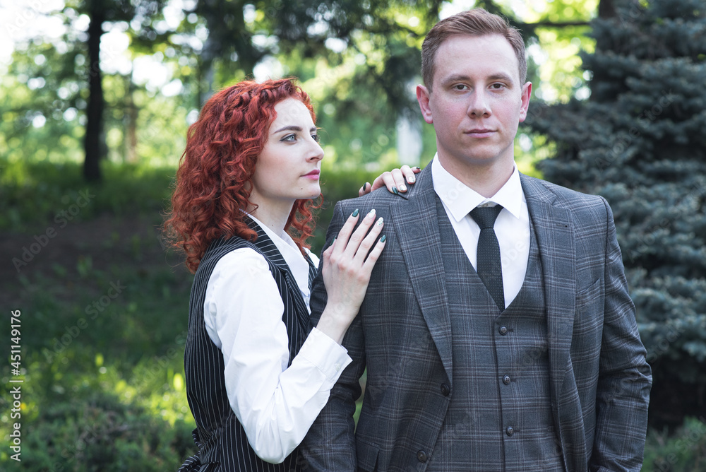 Redhead couple. Portrait of husband and wife in formal wear in nature Redhead couple. Portrait of husband and wife in formal wear in nature