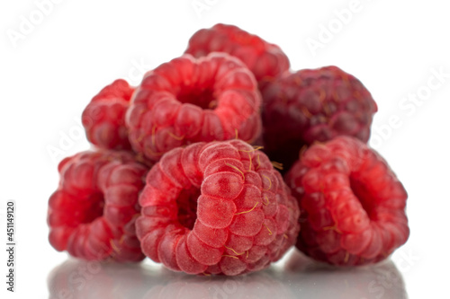 Several berries of ripe red raspberries, close-up, isolated on white.