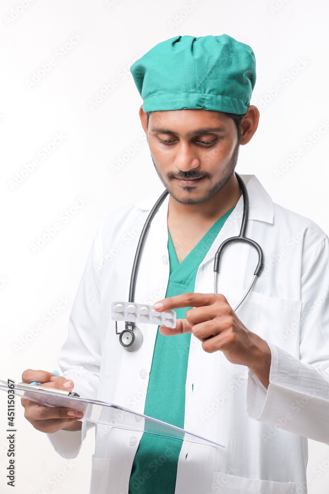 Young indian doctor checking medicine at clinic Young indian doctor checking medicine at clinic