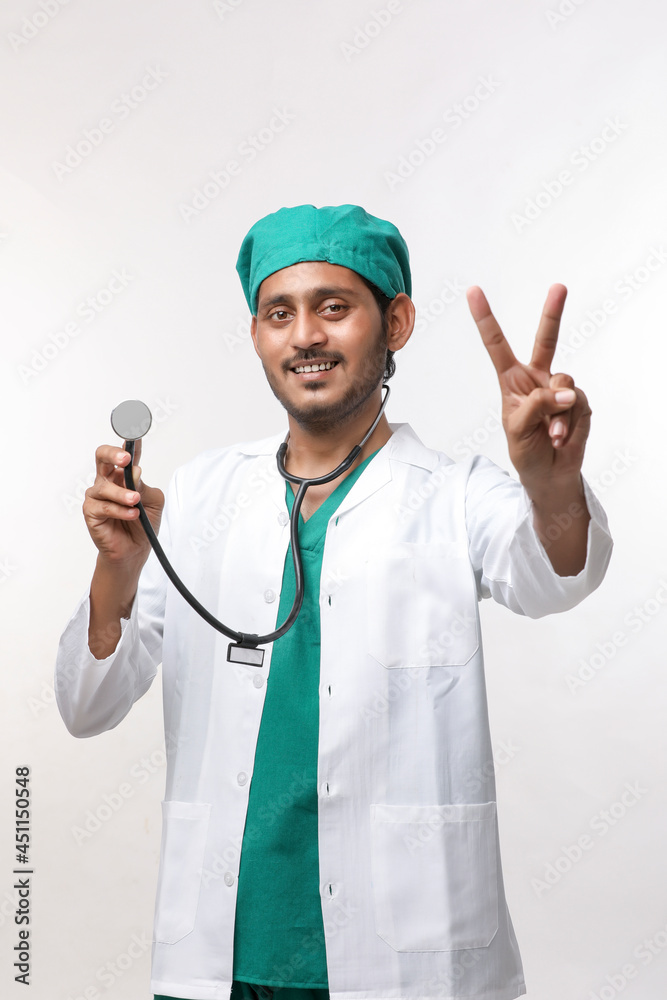 Young indian male Doctor holding stethoscope in hand on white background. Young indian male Doctor holding stethoscope in hand on white background.