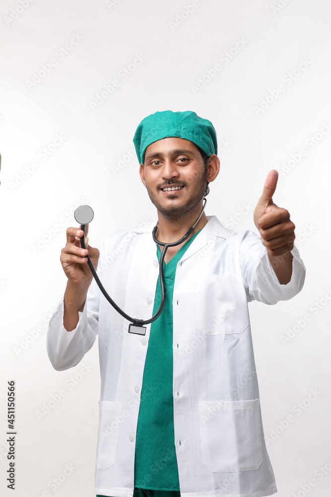 Young indian male Doctor holding stethoscope in hand on white background. Young indian male Doctor holding stethoscope in hand on white background.