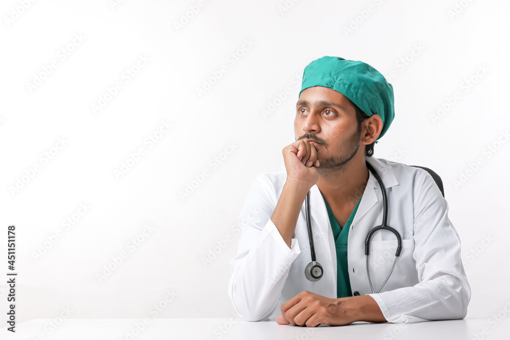 Young indian male doctor showing expression at clinic. Young indian male doctor showing expression at clinic.