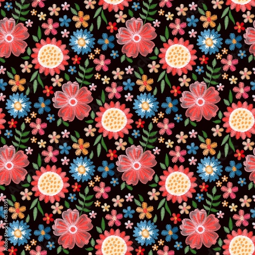 Charming abstract flowers embroidered on a black background. Seamless vector pattern for fabric.