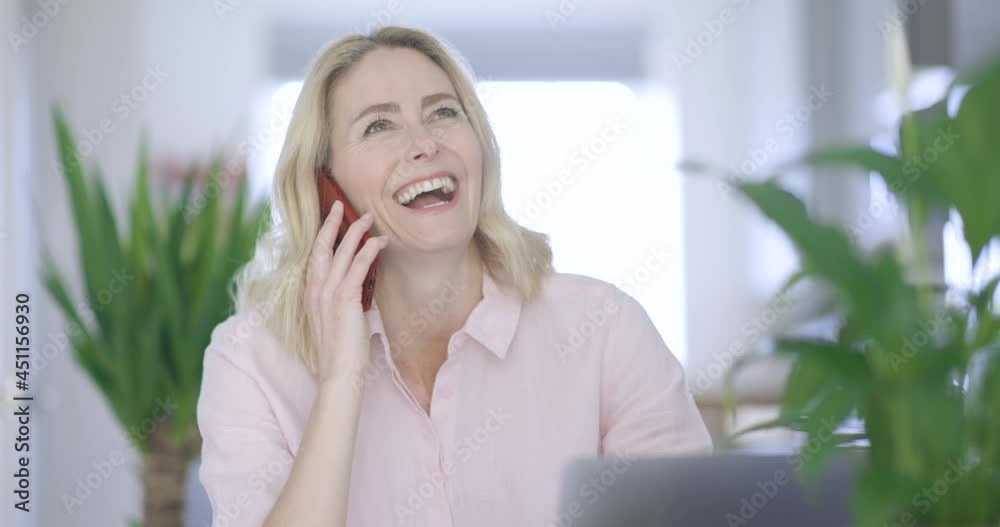 Laughing businesswoman talking on the phone Laughing businesswoman talking on the phone