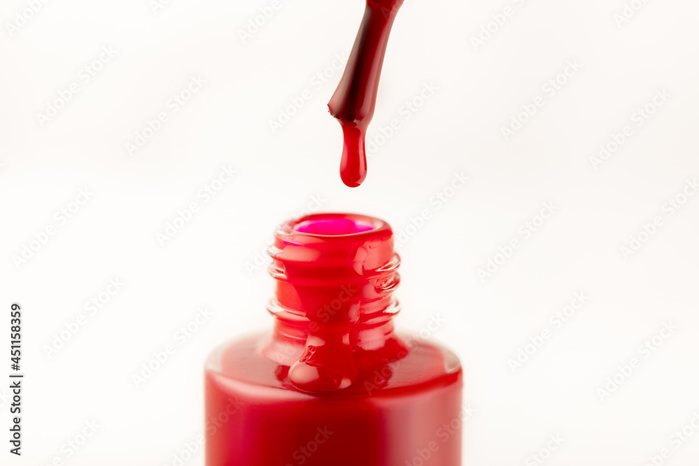 red nail polish with a drop on a brush close-up isolate on a white background, beauty concept red nail polish with a drop on a brush close-up isolate on a white background, beauty concept