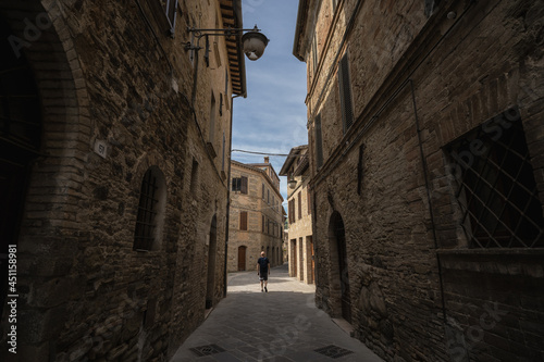 A young man walk along the streets of Bevagna  Umbria