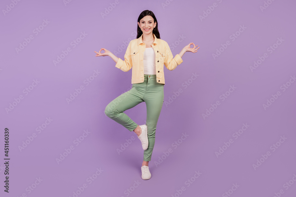 Portrait of focused happy girl meditate toothy smile on purple background Portrait of focused happy girl meditate toothy smile on purple background