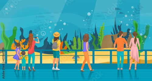 People watching underwater scenery with sea animals in oceanarium. Underwater fauna with fish, seaweed, whale, jellyfish. Marine world representatives. Oceanarium visitors look at fish in aquarium