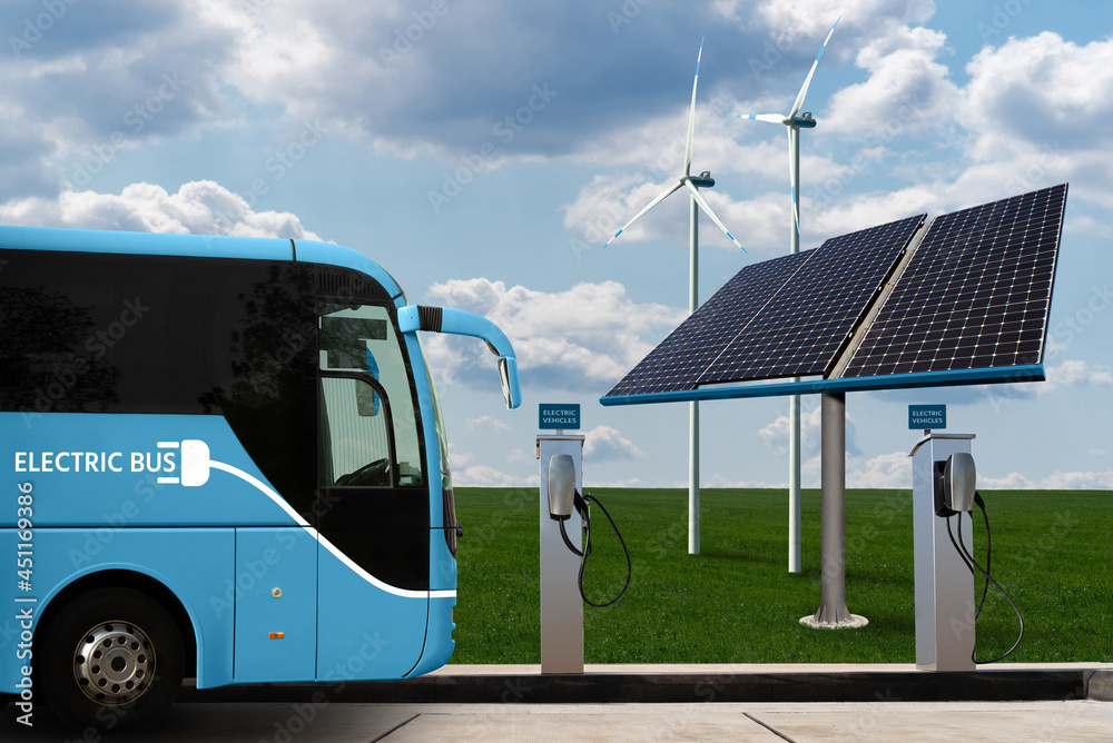 Electric bus with charging station on a background of Solar panels and wind  turbines. Clean mobility concept Stock Photo | Adobe Stock