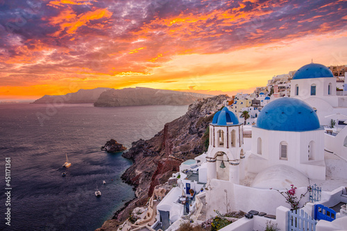 Stunning traveling destination scenic. Oia, Santorini island Greece. Amazing sunset sky with blue domes, caldera view, white architecture, luxury vacation in Europe. Famous popular landscape cityscape