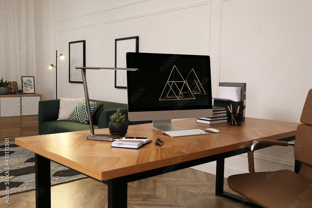 Workplace with computer on wooden desk in light room. Modern interior design Workplace with computer on wooden desk in light room. Modern interior design