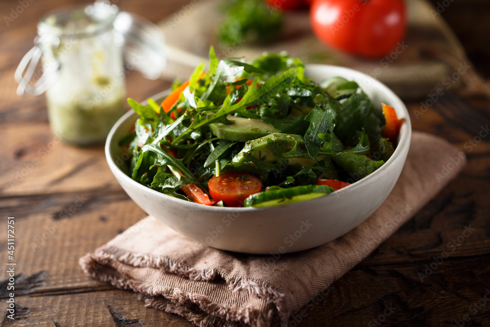 Healthy arugula salad with tomato and cucumber Healthy arugula salad with tomato and cucumber