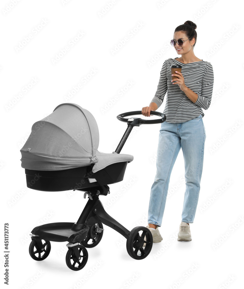 Happy young woman with cup of drink and baby stroller on white background Happy young woman with cup of drink and baby stroller on white background