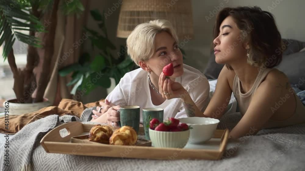 Lesbian couple breakfast woman eats strawberry with lover Spbd Lesbian couple breakfast woman eats strawberry with lover Spbd