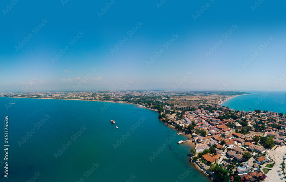 Wide panorama. Aerial view of the bay, ships and boats. Touristic place, ancient buildings, the Colosseum and the Temple of Apollo. Turkey, Manavgad, Side. Copy space