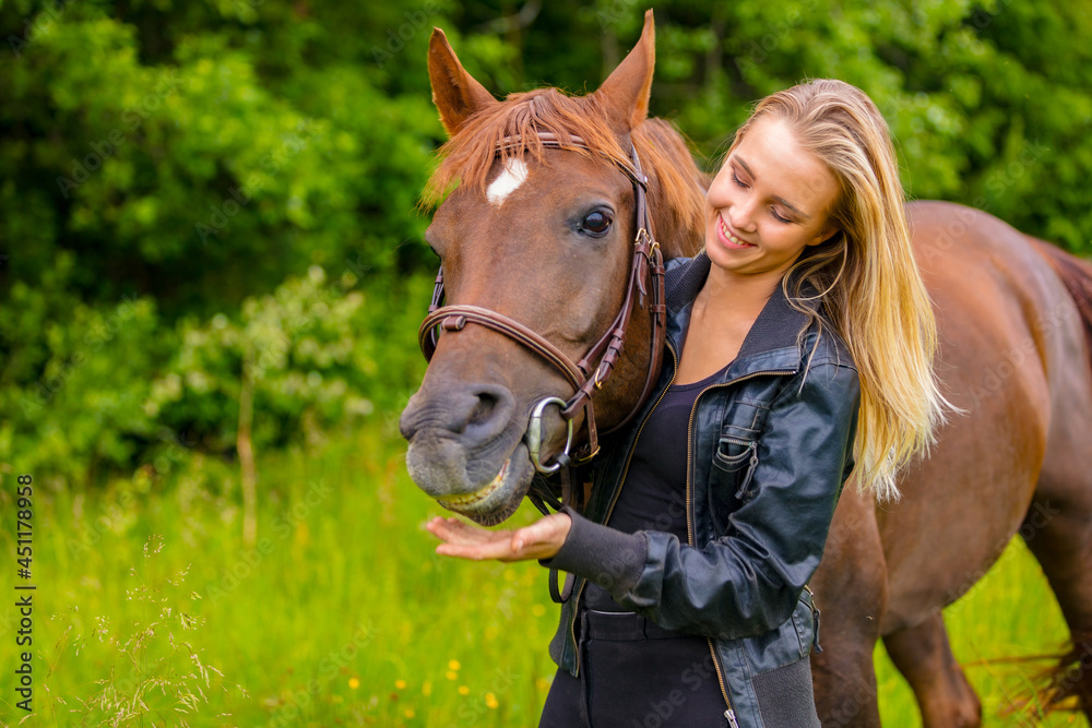 Fototapeta premium Smiling woman and her happy arabian horse friend in the nature