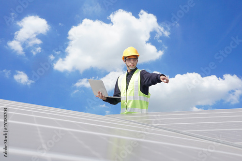 Asian engineer for solar panel inspection roof construction. Engineer worker installing solar panels outdoors
