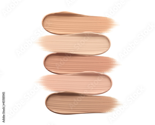 Different shades of liquid skin foundation on white background, top view