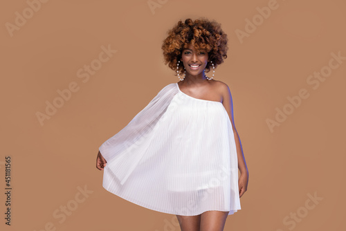 Elegant beautiful african american woman posing in white fashionable dress