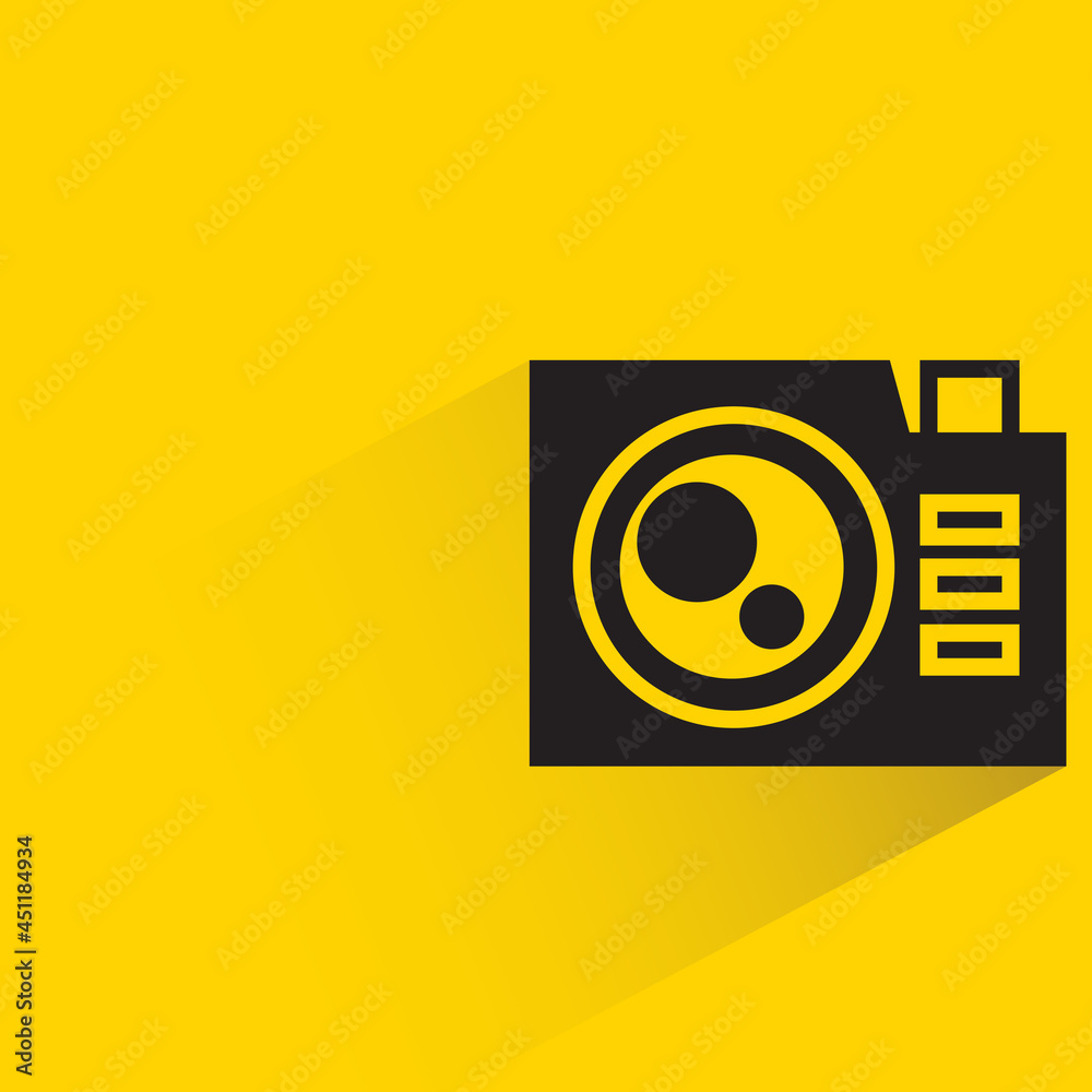 digital camera with shadow on yellow background digital camera with shadow on yellow background