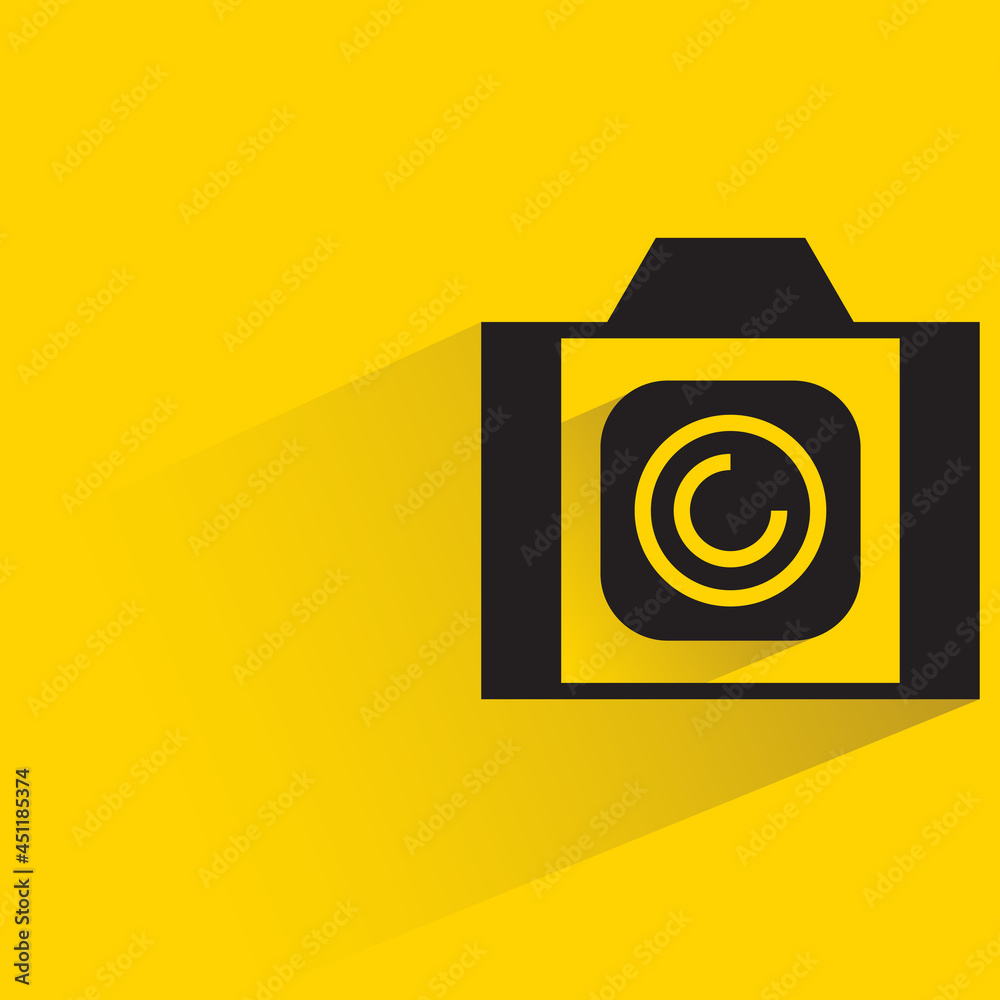 digital camera with shadow on yellow background digital camera with shadow on yellow background