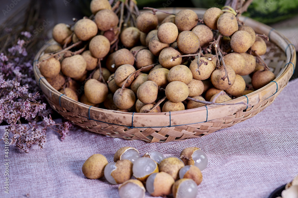 bunch of ripe longan fruit on bamboo basket bunch of ripe longan fruit on bamboo basket