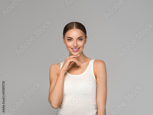 Beautiful woman healthy skin natural make up beauty smile over gray background
