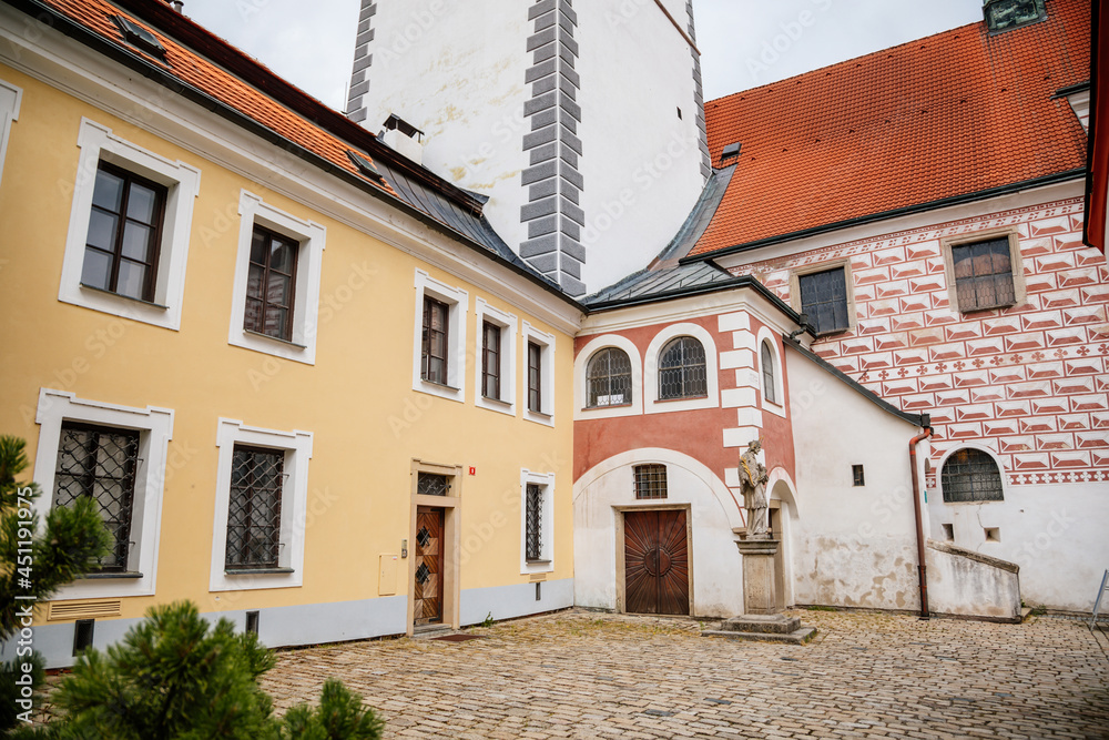 Pelhrimov, Czech Republic, 03 July 2021: gothic church of St. Bartholomew with observation tower at sunny summer day in center of town, sgraffito plaster in the form of red and white bricks on walls