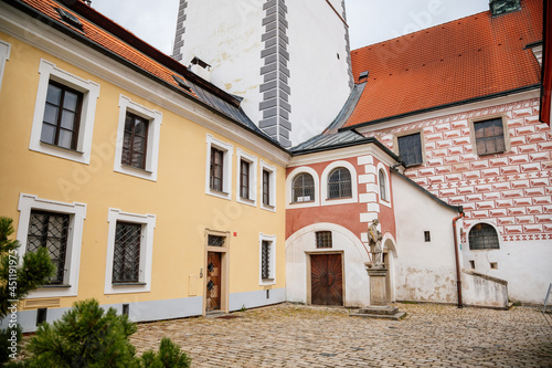 Pelhrimov, Czech Republic, 03 July 2021: gothic church of St. Bartholomew with observation tower at sunny summer day in center of town, sgraffito plaster in the form of red and white bricks on walls © AnnaRudnitskaya
