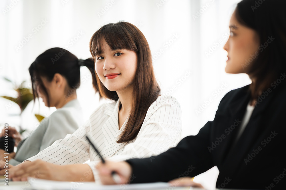 Asian business hold a small meeting inside the office or conference room. Brainstorm to exchange ideas. There are stock boards Laptops and tablets are communication tools. Unity teamwork concept. Asian business hold a small meeting inside the office or conference room. Brainstorm to exchange ideas. There are stock boards Laptops and tablets are communication tools. Unity teamwork concept.