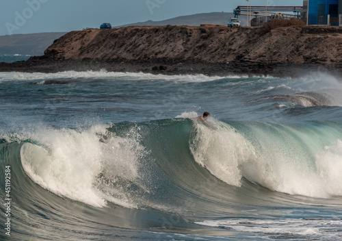 Bodyboarder in action on the ocean waves on the last hours of the  day in Gran Canaria. Canary islands.   photo